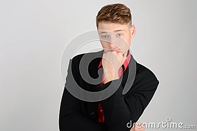 Young business man holding his head frowning. Man thinking and day dreaming. Stock Photo