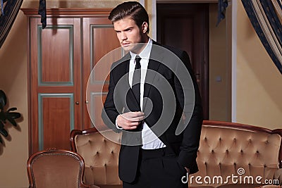Young business man holds hand in pocket Stock Photo