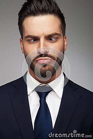 Young business man making a stupid face Stock Photo