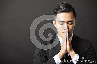 Young business man with pray gesture Stock Photo