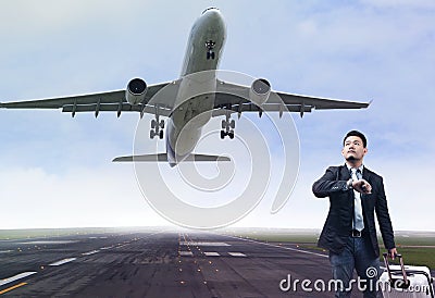 Young business man standing in airport runways with belonging lu Stock Photo