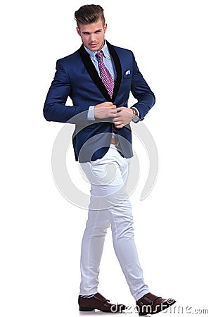 Young business man unbuttoning jacket while walking Stock Photo