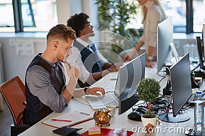 Young business man watching at his laptop with focus and concentration. making decision Stock Photo