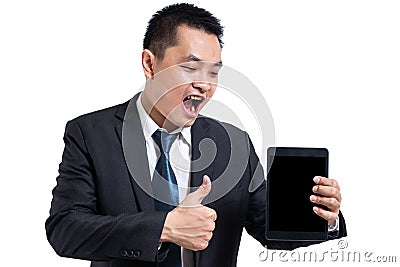 Young business man wear black suit working on digital tablet. Businessman hand holding tablet and hand thumbs up. Stock Photo