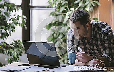 Young business man work on computer in his pleasant studio home Stock Photo