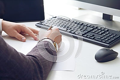Young business man working at the computer and papers on the table Stock Photo