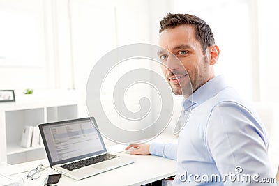 Young business man working at home on his laptop Stock Photo