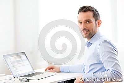 Young business man working at home on his laptop Stock Photo