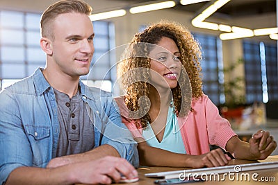 Young business people looking at computer monitor Stock Photo