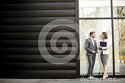 Young business people talking and viewing documents outdoor Stock Photo