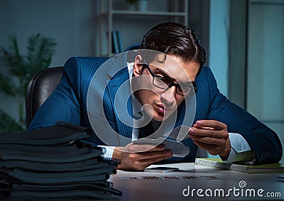 Young business playing cards late in office Stock Photo