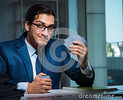 Young business playing cards late in office Stock Photo