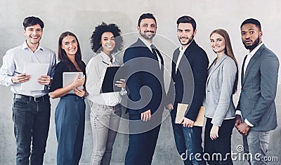 Young business team looking at camera in office Stock Photo