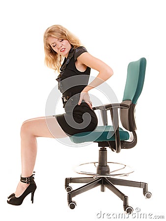 Young business woman with backache back pain. Stock Photo