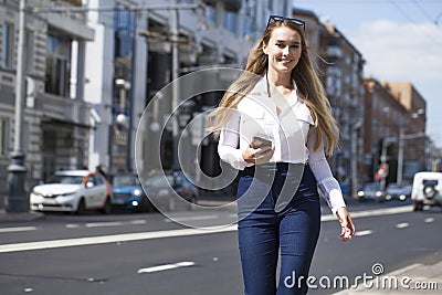 Young business woman with blue mirrored sunglasses calling by phone Stock Photo