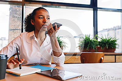 Young business woman conducts negotiate from cafe, Stock Photo