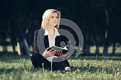 Young business woman with a folder in city park Stock Photo