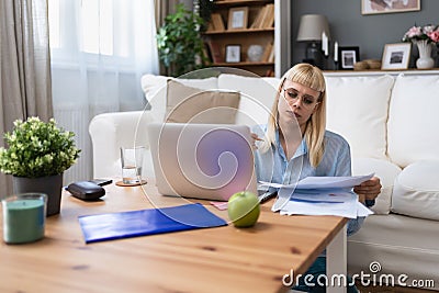 Young business woman freelance expatriate financial and digital marketing expert in smart casual working at home in home office in Stock Photo