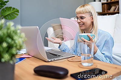 Young business woman freelance expatriate financial and digital marketing expert in smart casual working at home in home office Stock Photo