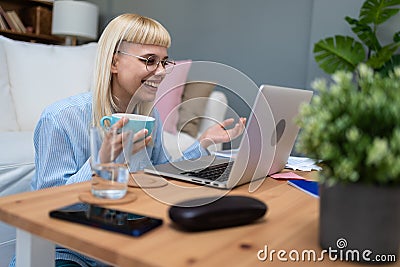 Young business woman freelance expatriate financial and digital marketing expert in smart casual working at home in home office Stock Photo