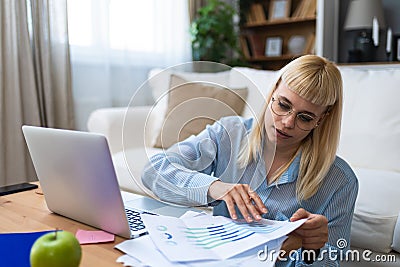 Young business woman freelance expatriate financial and digital marketing expert working at home in home office in smart casual Stock Photo