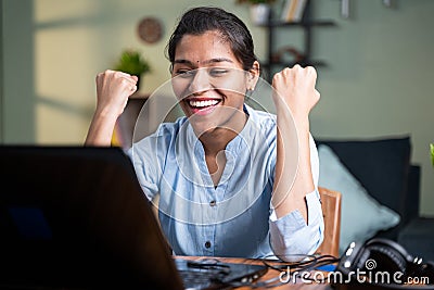 Young business woman got overjoyed by good news and started celebrating while working on laptop - Concept of new Job offer or Stock Photo