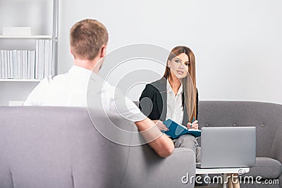 Young business woman and handsome businessman talking in office. Couple of freelancers. Stock Photo