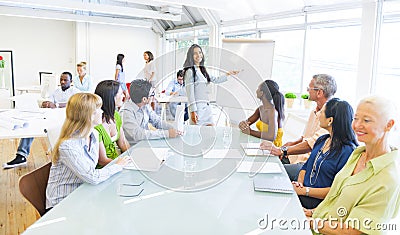 Young Business woman presenting in Office Stock Photo