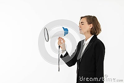 Young business woman is shouting through a megaphone Stock Photo