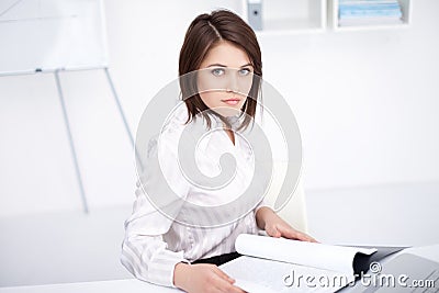 Young business woman sitting at desk at office Stock Photo