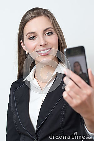 Young business woman is smiling while taking a selfie pciture Stock Photo