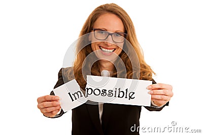 Young business woman tearing apart text impossible isolated over Stock Photo