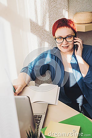 Woman with smartphone and laptop works. Concept for home office Stay home, study and work online, quarantine coronavirus Stock Photo