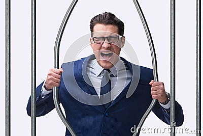 The young businessman behind the bars in prison Stock Photo