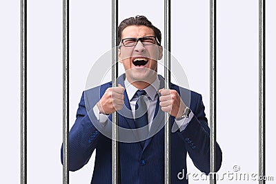 The young businessman behind the bars in prison Stock Photo