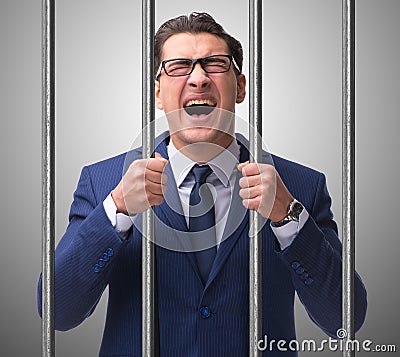 Young businessman behind the bars in prison Stock Photo