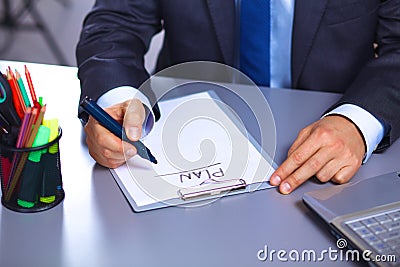 Young businessman behind the desk in the Office Stock Photo