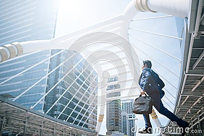 Young businessma running fast in a city Stock Photo