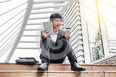 Young businessman buying online with a credit card and a tablet in the city Stock Photo