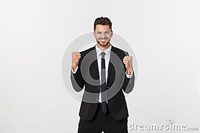 Young businessman celebrating his success over gray background. Stock Photo