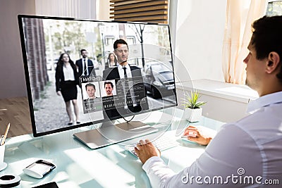 Businessman checking CCTV camera footage on computer Stock Photo