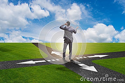 The young businessman at crossroads in uncertainty concept Stock Photo