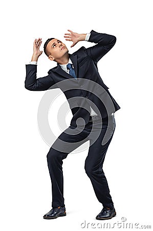 Young businessman in defensive pose afraid of something isolated on white background Stock Photo