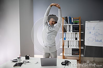 Young Businessman Doing Stretching Exercise Stock Photo