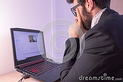 Young businessman is focusing on the call from his house desk Stock Photo