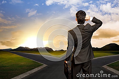Young businessman in front of a crossroad Stock Photo