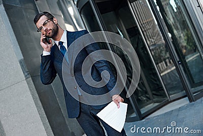 A young businessman with glasses and a beard is upset by a failed deal Stock Photo