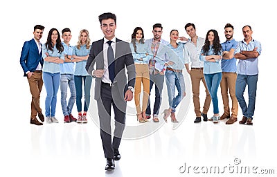 Young businessman group leader walks in front of the team Stock Photo