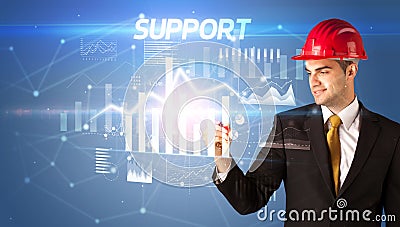 Young businessman with helmet drawing on virutal screen Stock Photo