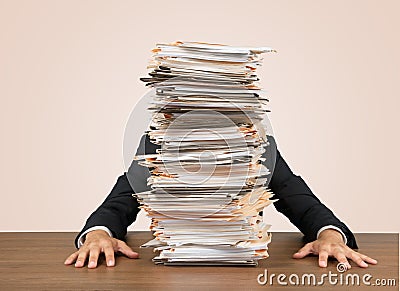 Young businessman hid behind with stack of papers Stock Photo